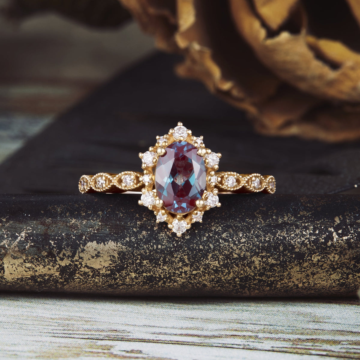 Delicate oval Alexandrite engagement ring with moissanite accents and twisted band.